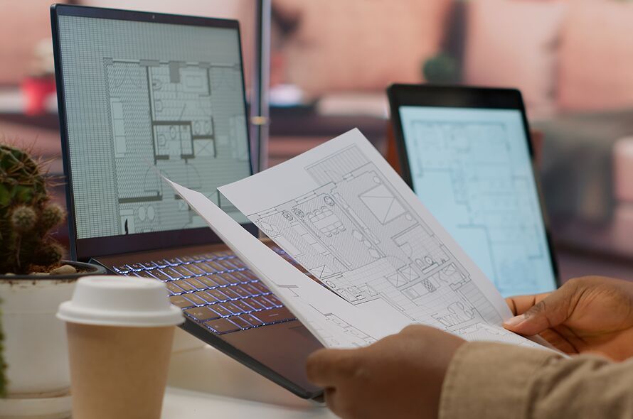 professional-entrepreneur-examining-blueprints-and-2025-02-20-00-11-40-utc 1